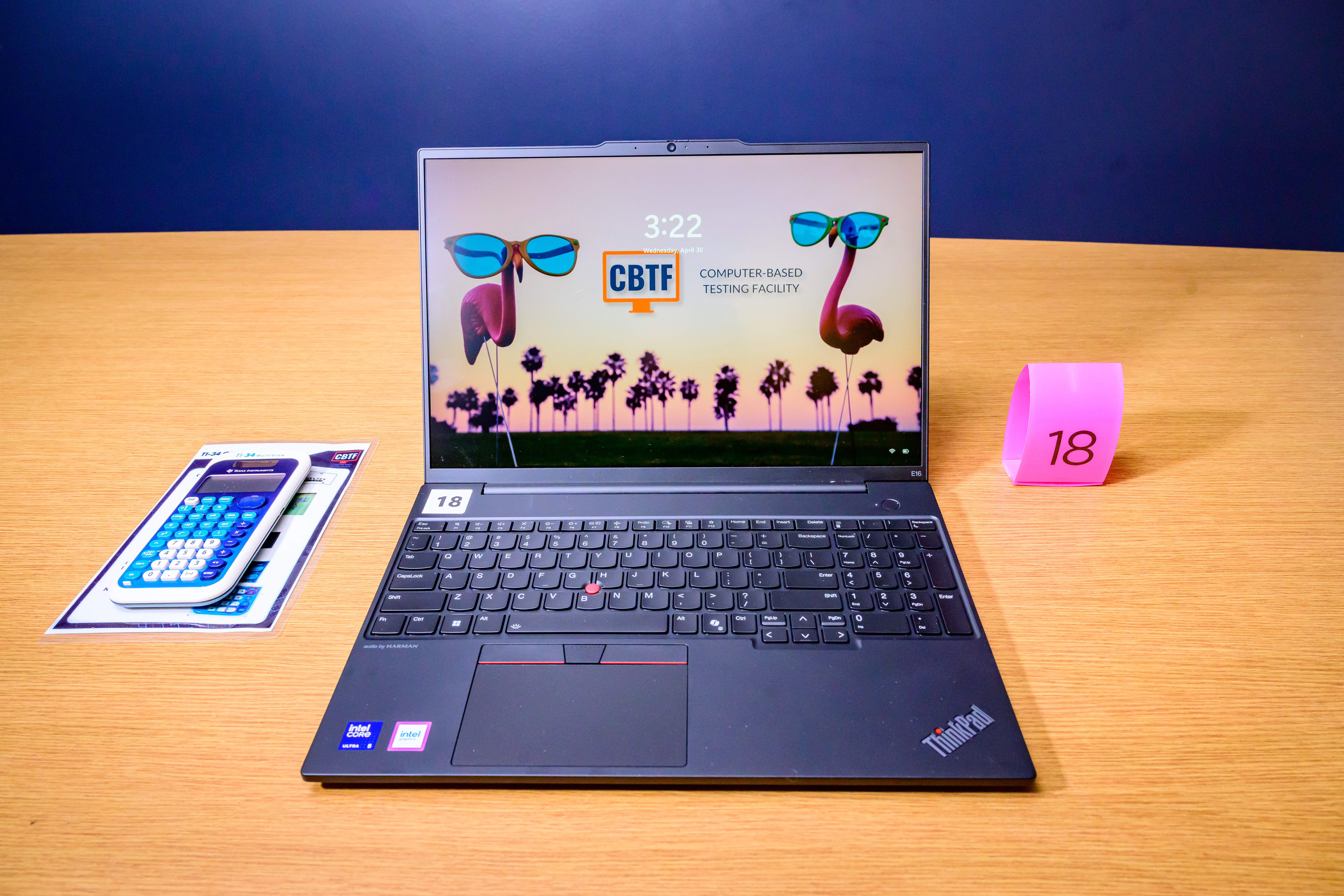 The picture shows a laptop centered on a desk with the CBTF flamingo background. To the left is a CBTF calculator.
